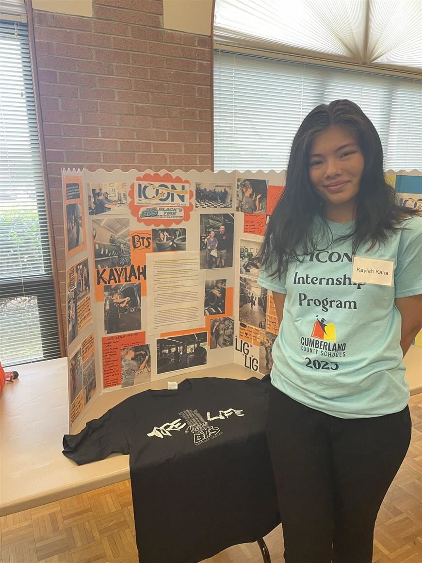 Student who participated in the ICON internship program standing in front of her poster board Student who participated in the ICON internship program standing in front of her poster board
